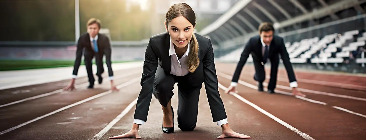 Photo of three business competitors on a race track in starting position representing competing for customers.