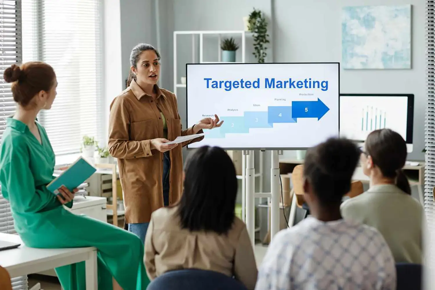 Image of a leader explaining targeted marketing strategy to her team.