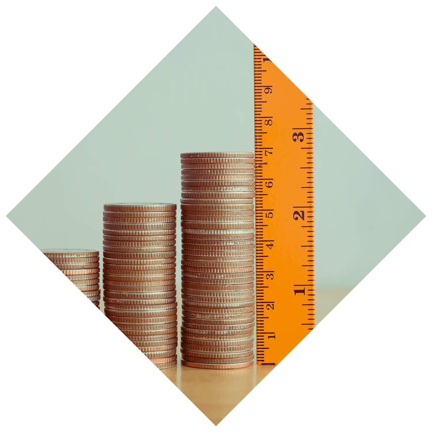 Image of stacked coins increasing in quantity with a ruler next to them.